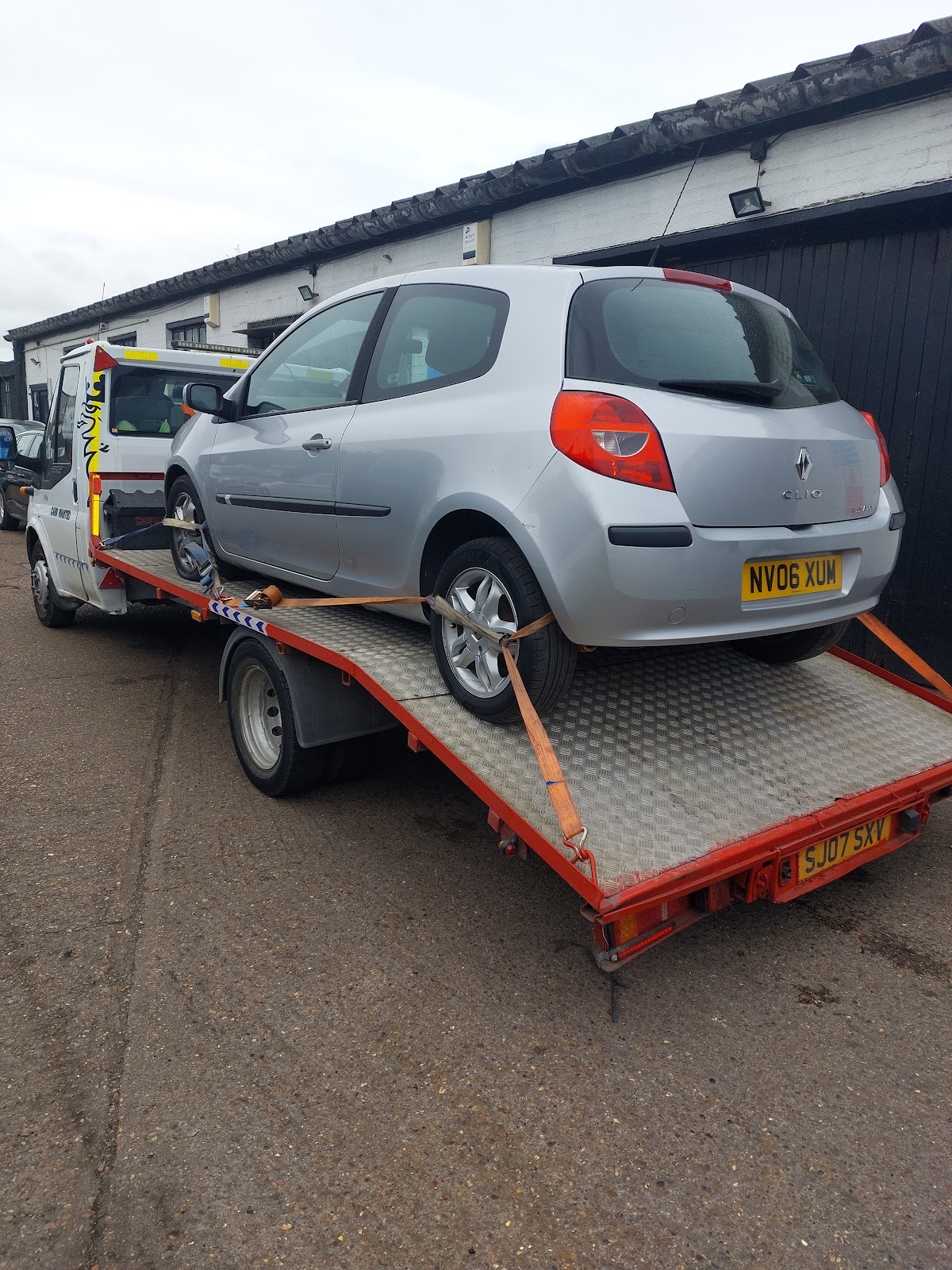 Mechanic working underneath a car on the ramp at Croydon Vehicle Services